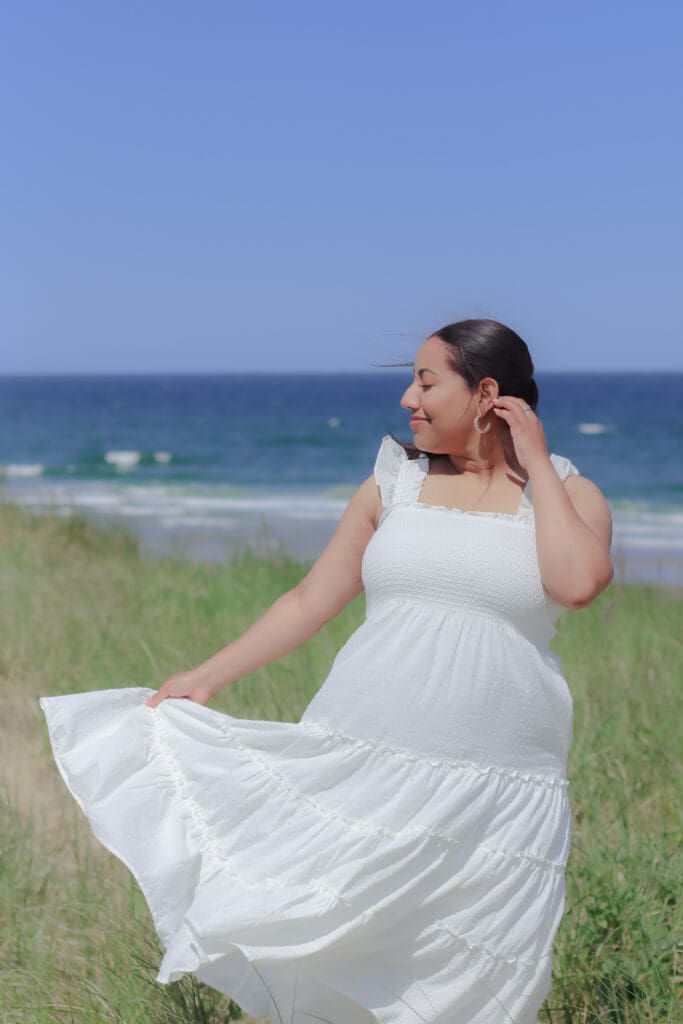 Woman in a summer hat during a portrait session in Boston at the beach.