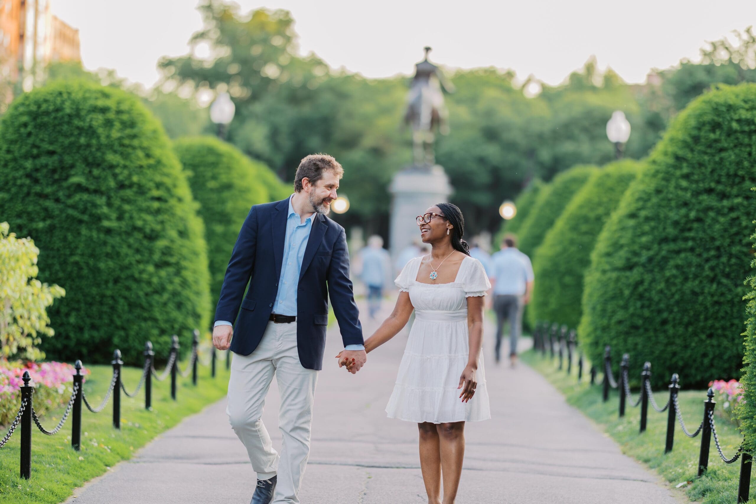 Couple taking romantic engagement photos in Boston Public Garden